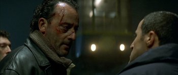 Movie still from “The Crimson Rivers” (2000), directed by Mathieu Kassovitz – A person with blood on his face; Close Up shot, Over the shoulder angle