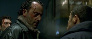 Movie still from “The Crimson Rivers” (2000), directed by Mathieu Kassovitz – A person with a bandage on his face; Close Up shot, Over the shoulder angle