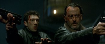 Movie still from “The Crimson Rivers” (2000), directed by Mathieu Kassovitz – Two men in leather jackets one of them is holding a knife in his hand; Close Up shot, Low angle