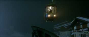 Movie still from “The Crimson Rivers” (2000), directed by Mathieu Kassovitz – A cable car is seen from below as it travels down the street; Extreme Wide shot, Low angle
