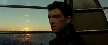 Movie still from “The Crimson Rivers” (2000), directed by Mathieu Kassovitz – A person wearing a leather jacket; Close Up shot, Low angle