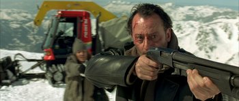 Movie still from “The Crimson Rivers” (2000), directed by Mathieu Kassovitz – A man is aiming a gun at the camera; Close Up shot, Low angle