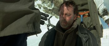 Movie still from “The Crimson Rivers” (2000), directed by Mathieu Kassovitz – A person with a beard; Close Up shot, Over the shoulder angle