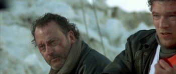 Movie still from “The Crimson Rivers” (2000), directed by Mathieu Kassovitz – A person wearing a leather jacket; Close Up shot, Low angle