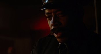 Movie still from “The Crow” (1994), directed by Alex Proyas – A person wearing a uniform; Close Up shot, Low angle