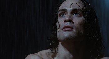 Movie still from “The Crow” (1994), directed by Alex Proyas – A person with wet hair; Close Up shot, Low angle