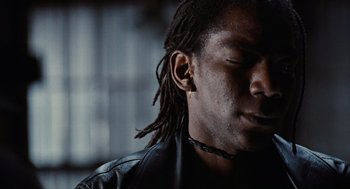 Movie still from “The Crow” (1994), directed by Alex Proyas – A person with dreadlocks; Close Up shot, Over the shoulder angle