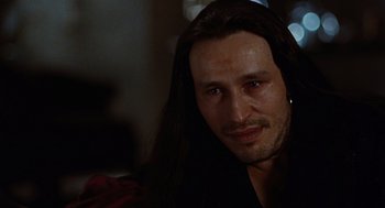 Movie still from “The Crow” (1994), directed by Alex Proyas – A person with long black hair; Close Up shot, Over the shoulder angle