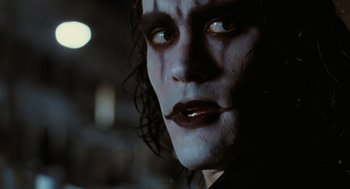 Movie still from “The Crow” (1994), directed by Alex Proyas – A person wearing makeup; Close Up shot, Over the shoulder angle