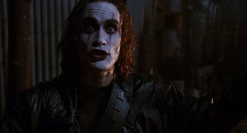 Movie still from “The Crow” (1994), directed by Alex Proyas – A person wearing a leather jacket; Close Up shot, Low angle