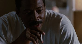 Movie still from “The Crow” (1994), directed by Alex Proyas – A person smoking a cigarette; Close Up shot, Low angle