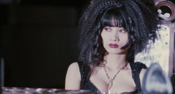 Movie still from “The Crow” (1994), directed by Alex Proyas – A woman in a black dress and a black wig; Close Up shot, Low angle