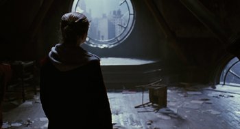 Movie still from “The Crow” (1994), directed by Alex Proyas – A woman looking out of a window at a city; Wide shot, Low angle