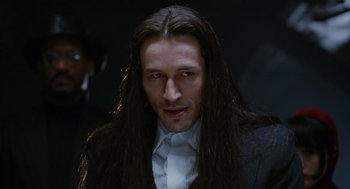 Movie still from “The Crow” (1994), directed by Alex Proyas – A person with long hair; Close Up shot, Over the shoulder angle