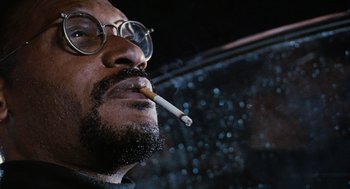 Movie still from “The Crow” (1994), directed by Alex Proyas – A person smoking a cigarette; Close Up shot, Low angle