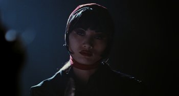 Movie still from “The Crow” (1994), directed by Alex Proyas – A woman wearing a red hat and a black shirt; Close Up shot, Low angle