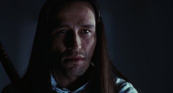 Movie still from “The Crow” (1994), directed by Alex Proyas – A person with long brown hair; Close Up shot, Low angle