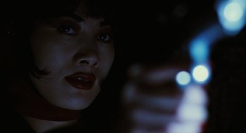 Movie still from “The Crow” (1994), directed by Alex Proyas – A person using a cell phone; Close Up shot, Low angle