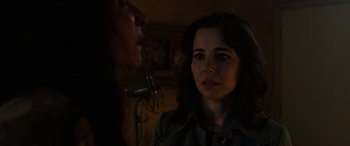 Movie still from “The Curse of La Llorona” (2019), directed by Michael Chaves – A woman standing next to a man in a dark room; Close Up shot, Over the shoulder angle