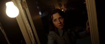 Movie still from “The Curse of La Llorona” (2019), directed by Michael Chaves – A woman is looking at the camera in a dark room; Close Up shot, Over the shoulder angle