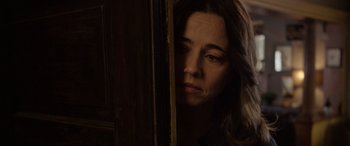 Movie still from “The Curse of La Llorona” (2019), directed by Michael Chaves – A person leaning against a door; Close Up shot, Over the shoulder angle
