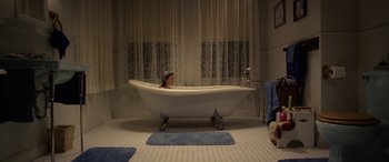 Movie still from “The Curse of La Llorona” (2019), directed by Michael Chaves – A woman sitting in a bath tub in a bathroom; Wide shot, High angle