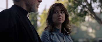 Movie still from “The Curse of La Llorona” (2019), directed by Michael Chaves – A man and a woman standing next to each other in front of trees; Close Up shot, Over the shoulder angle