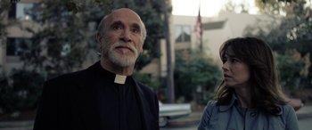 Movie still from “The Curse of La Llorona” (2019), directed by Michael Chaves – An older man and a young woman standing next to each other on the street; Medium shot, Low angle