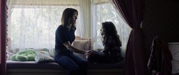 Movie still from “The Curse of La Llorona” (2019), directed by Michael Chaves – A woman and a girl sitting on a window sill; Medium shot, Over the shoulder angle