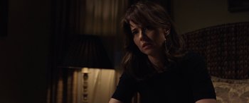 Movie still from “The Curse of La Llorona” (2019), directed by Michael Chaves – A woman sitting in front of a lamp in a dark room; Close Up shot, Over the shoulder angle