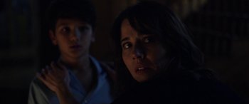 Movie still from “The Curse of La Llorona” (2019), directed by Michael Chaves – A woman and a boy in a dark room; Close Up shot, Over the shoulder angle