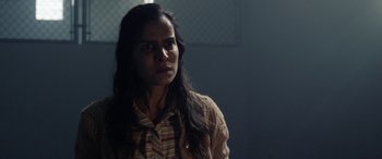 Movie still from “The Curse of La Llorona” (2019), directed by Michael Chaves – A woman with long black hair standing in a dark room; Close Up shot, Over the shoulder angle
