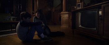 Movie still from “The Curse of La Llorona” (2019), directed by Michael Chaves – A woman sitting on the floor in a dark room; Wide shot, High angle