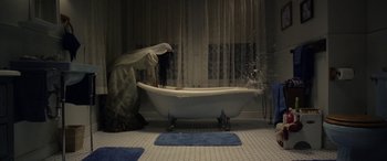 Movie still from “The Curse of La Llorona” (2019), directed by Michael Chaves – A woman in a white robe standing in front of a bath tub; Wide shot, High angle