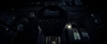 Movie still from “The Curse of La Llorona” (2019), directed by Michael Chaves – A man standing in front of a building at night; Wide shot, Low angle