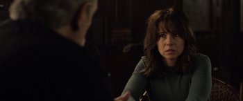 Movie still from “The Curse of La Llorona” (2019), directed by Michael Chaves – A woman sitting in front of a man in front of a table; Close Up shot, Over the shoulder angle