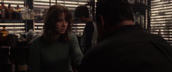 Movie still from “The Curse of La Llorona” (2019), directed by Michael Chaves – A woman is talking to a man in a dark room; Medium shot, Over the shoulder angle