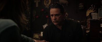 Movie still from “The Curse of La Llorona” (2019), directed by Michael Chaves – A man sitting at a table in front of a clock; Close Up shot, Over the shoulder angle