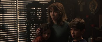 Movie still from “The Curse of La Llorona” (2019), directed by Michael Chaves – A woman and two children standing next to each other in front of a building; Close Up shot, Over the shoulder angle