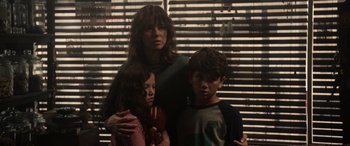 Movie still from “The Curse of La Llorona” (2019), directed by Michael Chaves – A woman and two children standing next to each other; Medium shot, Over the shoulder angle
