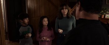 Movie still from “The Curse of La Llorona” (2019), directed by Michael Chaves – A woman and a young girl holding wii remotes in their hands; Medium shot, Over the shoulder angle