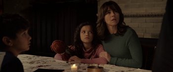 Movie still from “The Curse of La Llorona” (2019), directed by Michael Chaves – A woman sitting next to a young girl at a table; Medium shot, Over the shoulder angle