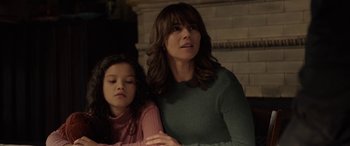 Movie still from “The Curse of La Llorona” (2019), directed by Michael Chaves – A woman sitting next to a young girl in front of a fireplace; Close Up shot, Over the shoulder angle