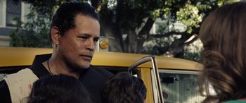 Movie still from “The Curse of La Llorona” (2019), directed by Michael Chaves – A man standing next to a yellow taxi cab; Close Up shot, Over the shoulder angle