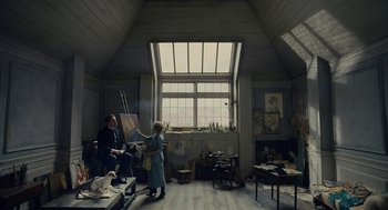 Movie still from “The Danish Girl” (2015), directed by Tom Hooper – A man and a woman painting in an artist's studio; Wide shot, Low angle