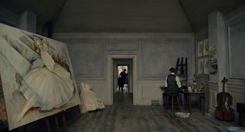 Movie still from “The Danish Girl” (2015), directed by Tom Hooper – A man standing in front of an easel in a room; Wide shot, Low angle