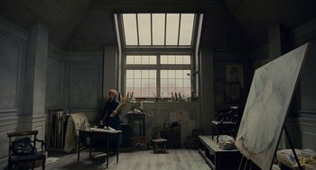 Movie still from “The Danish Girl” (2015), directed by Tom Hooper – A woman standing in front of a window in a room; Wide shot, Low angle