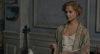Movie still from “The Danish Girl” (2015), directed by Tom Hooper – A young woman holding a cigarette in her mouth; Close Up shot, Over the shoulder angle
