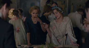 Movie still from “The Danish Girl” (2015), directed by Tom Hooper – Two women are looking at a cell phone; Medium shot, Over the shoulder angle