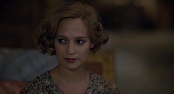 Movie still from “The Danish Girl” (2015), directed by Tom Hooper – A young woman with brown hair wearing a floral dress; Close Up shot, Over the shoulder angle